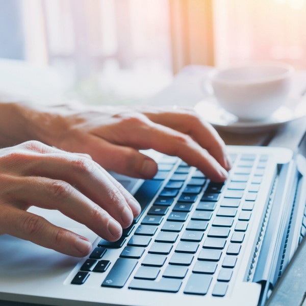 close up of hands of business person working on computer, man using internet and social media